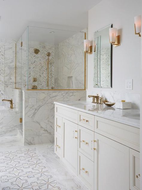 Ivory mosaic floor tiles framed by marble tiles are positioned in front of an ivory dual washstand boasting brass and glass pulls and a white quartz countertop fitted with round his and her sinks with gold faucets. Mosaic Floor Tiles, Gold Bad, Lighting Bathroom, Modern Ideas, Mosaic Floor, Bad Inspiration, Master Bath Remodel, Quartz Countertop, White Quartz Countertop