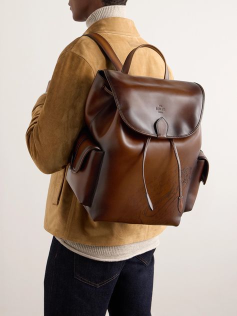 Berluti's backpack is crafted from its own Venezia leather in a deep 'Cacao' brown. Its two external pockets are sized for quick-access essentials – like hand sanitiser and aftershave – while its interior can easily stow a spare sweater, flask and a couple of books. It secures with drawstrings and a magnetic flap. Backpack Leather Man, Leather Photography Product, Men’s Backpack, Leather Backpack Aesthetic, Porter Backpack, Mens Backpack Fashion, Weekend Bags, Aesthetic Backpack, Men Backpack