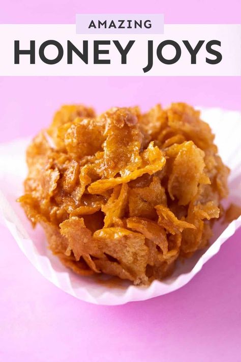 Crispy, crunchy Honey Joys made from scratch. These buttery treats are made using Cornflakes, honey and butter - and my recipe boasts a secret ingredient that makes them extra irresistible. They’re perfect for parties and celebrations! Recipe from sweetestmenu.com #honeyjoys #cornflakes #baking Honey Joy Slice, Honey Cornflakes, Honey Joys Recipe, Eggless Cookie Dough, Best Honey, Small Desserts, Summer Dessert Recipes, Honey Butter, Sweet Snacks Recipes