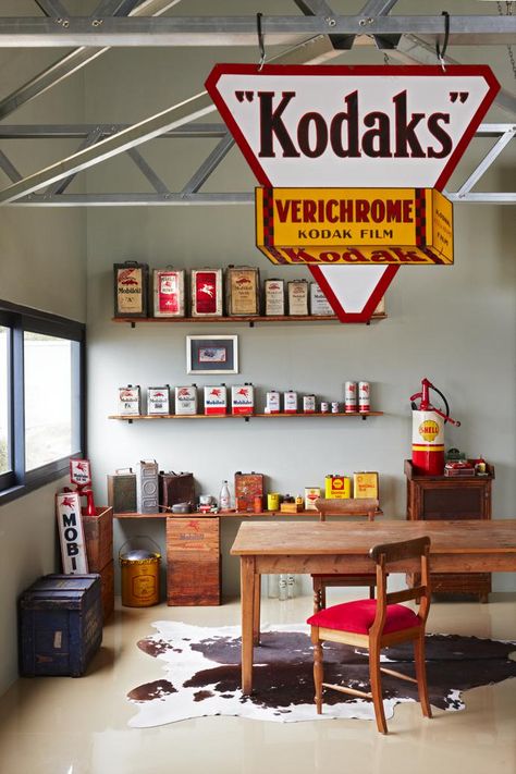 The “oil wall” in the dining section of Dieter’s extended man cave features wooden display shelves by Skull Gear. Man Cave Shelf, Wooden Display Shelves, Kodak Film, Wooden Display, Display Shelves, Man Cave, Front Door, Garage, Art Design