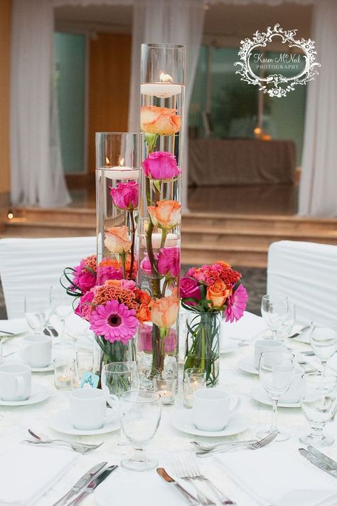 Decor For Round Tables Wedding, Colorful Candle Centerpieces, Flowers Candles Centerpiece, Pink Orange Decorations, Pink Orange Yellow Wedding Centerpieces, Fuschia Orange Wedding, Orange And Pink Wedding Theme, Floating Candles Wedding Centerpieces, Pink And Orange Wedding Theme