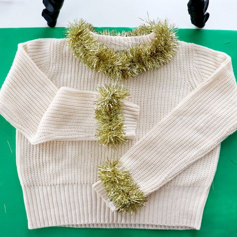 Gold Tinsel Cuff and Neckline Holiday Sweater | 5 DIY Temporary Christmas Sweater Party Outfit Ideas Tinsel Outfit Diy, Diy Tinsel Sweater, Christmas Sweater Party Outfit, Sweater Design Ideas, Sweater Party Outfit, Creative Ugly Christmas Sweater, Ugly Christmas Outfit, Tinsel Sweater, Ugly Christmas Sweater Ornament