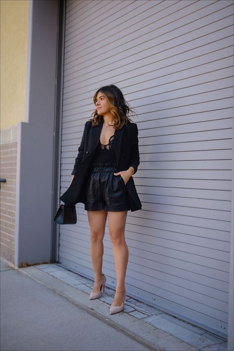 Today CHIC TALK is sharing this chic total black look. She bought the body suit from @freepeople and paired it with faux leather shorts and a black blazer. This outfit is perfect for your next date night or girls night out! Follow for more summer outfit ideas, elevated fashion, and style guides. Black Shorts Outfit Dressy, Leather Shorts Night Outfit, Black Shorts With Blazer Outfits, Black Suit Shorts Outfit, Black Shorts Office Outfit, Faux Leather Shorts Outfit Going Out, Leather Shorts Blazer Outfit, Going Out Shorts Outfit Night, Leather Shorts And Blazer Outfit