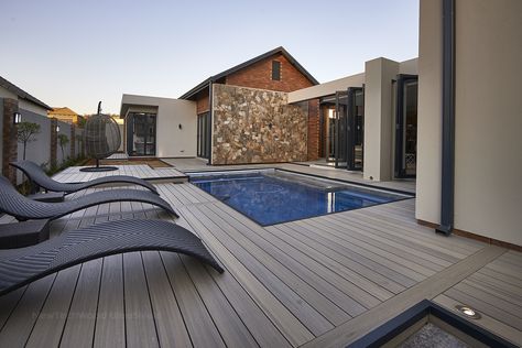 Check out this awesome Roman Antique installation around a pool. Simply Breathtaking! Composite Decking Pool, Decking Around Pool, Composite Deck Ideas, Wood Pool Deck, Roman Antique, Decks Around Pools, Aesthetic Pool, Decking Options, Composite Decking Boards