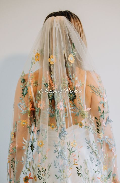 Wildflower veil has colorful 3D floral embroidery. The veil depicts colorful embroidered flowers and stems. 50 inches wide with slight gathering. This item is made to order. The veil in the photo is 60" long in tan tulle. If you need a different length please let me know and I will happily accommodate If you want  a sample please message me. **These veils are made to order; because of this, we do not offer returns or exchanges.** **If you are ordering outside of the USA: customs taxes may be cha Floral Print Wedding Dress, Embroidered Veil, Blue Wedding Gowns, Veil Floral, Dusty Blue Dress, Dress Clipart, Lace Veils Bridal, Floral Veil, Flower Veil