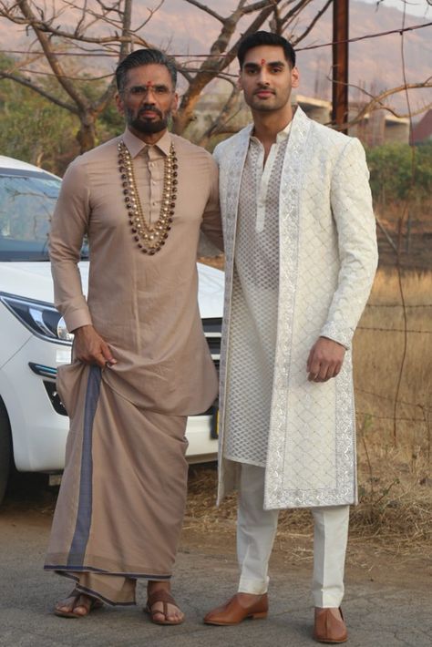 Cricketer KL Rahul and actor Athiya Shetty’s wedding has been one of the most anticipated celebrity shaadis of 2023. The nuptial that took place at actor and Athiya’s father Suniel Shetty’s Bungalow in Khandala was an intimate affair with no-phone policy being the norm for the guests. However, now the pictures from the wedding are out and we can’t keep calm. While we may need to wait some more for the pictures of the ‘couple of the moment’, we have dad and brother Shetty’s pictures out now and t Wedding Brothers Outfit, Suit For Indian Men, Brides Brother Outfit Indian, Brother Wedding Dress For Men, Groom Brother Outfit Indian, Latest Sherwani Designs For Groom, Groom Dress For Wedding, Athiya Shetty And Kl Rahul, Ahan Shetty