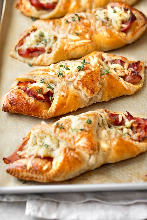 These warm, flaky ham and cheese croissants are easy to prep at home, and make for a delicious cafe-inspired meal with a crisp green salad! | thecozyapron.com #hamandcheesecroissants #hamandcheesecroissantsrecipe #hamandcheesecroissantsbaked #hamcheesecroissants #hamandcheesecroissantspuffpastry Easy Ham And Cheese Croissant, Croissant Grilled Cheese, Ham And Cheese Croissant Roll Ups, Ham And Cheese Croissants, Eggs Muffins, Croissant Roll, Ham And Cheese Croissant, Fun Apps, Cheese Croissant