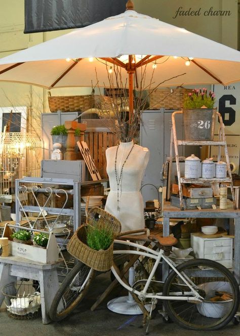 Umbrellas as Booth Decor!!! Watch for inexpensive patio umbrellas at yard sales. They are great eye-catching additions to indoor or outdoor booths.  Remove the old icky fabric and redo them. You don't have to do an expert seamstress job. I have seen some examples where they draped, glued, and/or stapled fabric or lace tablecloths over the top and it looked fabulous. If the original umbrella fabric is in good shape, you might just add some interesting fringe or trim.   Take a look at these exampl Vintage Market Booth, Flea Market Booth, Antique Booth Displays, Stall Display, Antique Booth Ideas, Vintage Flea Market, Booth Decor, Transforming Furniture, Craft Booth Displays