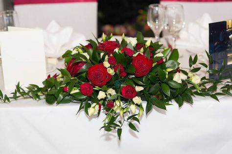 Red roses in wedding top table arrangement by Apple Blossom Bridal Table Flowers, Roses Arrangements, Red Roses Centerpieces, Top Table Flowers, Head Table Wedding Decorations, Wedding Top Table, Red And White Weddings, Table Flower Arrangements, Red Wedding Theme