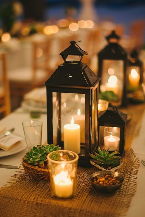 Add a cozy, romantic ambiance to wedding tables with candle centerpieces. Discover more ideas here. Eucalyptus Candle Centerpiece, Wedding Lantern Centerpieces, Wedding Tablescapes Long, Beachy Centerpieces, Candlelight Centerpieces, Romantic Centerpieces, Wedding Centerpiece Ideas, Candlelit Wedding, Cozy Romantic