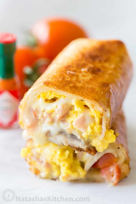 These Breakfast Burritos will make a breakfast person out of you. Crisp on the outside and filled with egg, ham and cheese. Easy freezer breakfast burritos! #breakfastburritos #breakfastburritorecipe #breakfastburrito #breakfast #natashaskitchen Burritos Freezer, Natasha Kitchen, Breakfast Burritos Frozen, Freezer Breakfast Burritos, Burrito Recipe, Breakfast Burritos Recipe, Frozen Breakfast, Breakfast Burrito, Burritos Recipe