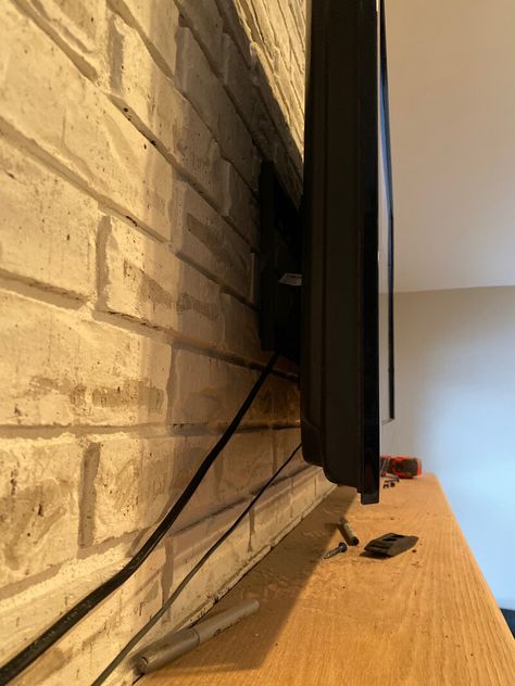 How to Mount a TV Over a Brick Fireplace - Hide Tv Cords Above Fireplace, Hiding Wires Mounted Tv, Hiding Tv Cords On Wall, Above Fireplace Ideas, Hide Tv Cords, Fireplace Tv Mount, Tv Above Fireplace, Tv Cords, Dollar Diy