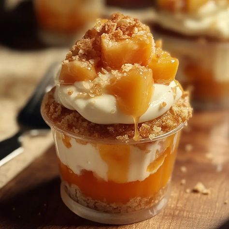 Peach Cobbler Cheesecake Cups Peach Cobbler Parfait, Peach Cheesecake Cobbler, Peach Cobbler Cheesecake Cups, Mini Peach Cobbler, Peach Cobbler Cupcakes, Peach Cobbler Cheesecake, Peanut Butter Cream Pie, Peach Cheesecake, Cheesecake Parfaits