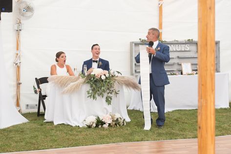 Lol!  You gotta love our father of the bride's long, unscrolled paper with notes of his congratulatory speech / toast to the newlyweds as they sat at their beautiful sweetheart table.  #FOB #SweetheartTable #SweetheartTableDecor #PampasGrass #White #Tent #BackyardWedding #Wedding #DonutDisplay #WeddingDonuts #List #FathersSpeech #Toast #Bride #Groom #Blue #Suit #NavyBlue #Green #Eucalyptus #Blush #Peach #Black #GardenChairs #LongTablecloths #Reception Backyard Woods, Boho Backyard, Donut Display, Woods Wedding, Sweetheart Table Decor, Wedding Donuts, Floral Stationery, Green Eucalyptus, Wedding Speech