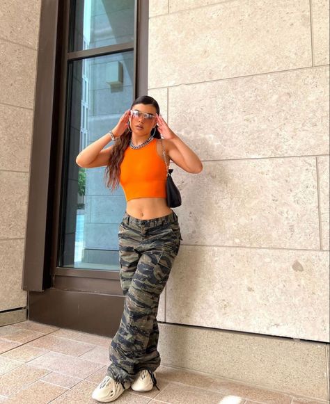 Camo Pants And Orange Top, Army And Orange Outfit, Camo With Orange Outfit, Army Cargos Outfits, Light Camo Pants Outfit, Camo Cargo Outfit, Camo Pants Outfit Baddie, Army Cargo Pants Outfit, Army Pants Outfit