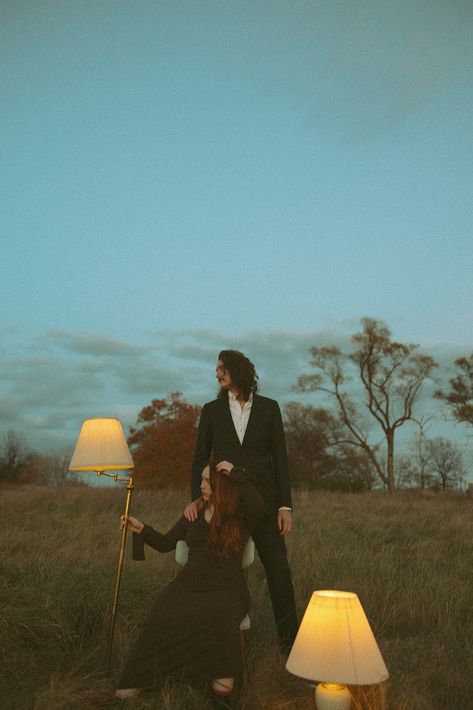 Couple sitting in an open field with lampshades posing for photos. Get inspired by more artsy engagement photo poses and artsy engagement photo ideas. Book Marissa for your Detroit engagement photos or Detroit wedding photography at marissadillonphotography.com! Grunge Engagement Photos, Alt Engagement Photos, Fantasy Engagement Photos, Unconventional Engagement Photos, Field Couples Photoshoot, Unique Couples Photography, Unique Couples Photoshoot, Feelings Board, Relationship Feelings