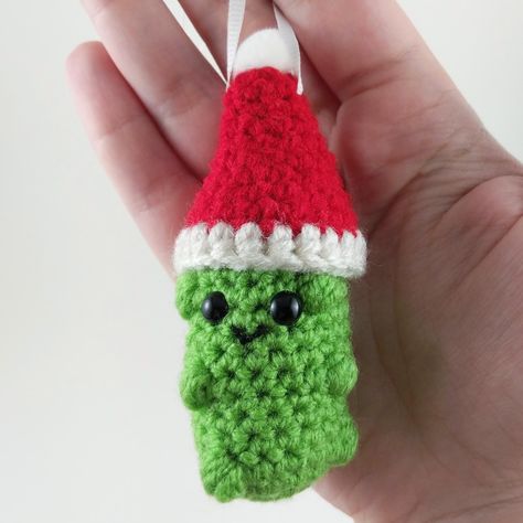 This cute and fun Christmas pickle ornament is sure to get a laugh from family and friends.  The pickle body is made using a combination of single crochet and puff stitch to make the little "pickle bumps".  This pickle is made using continuous rounds for the pickle body, and the hat is made with joined rounds.  Fairly quick to make, the pickle can be finished in 1-2 hours.  Hat can either be sewn on or glued on, as well as the pom-pom - whichever method you prefer. Crochet Pants Pattern, Christmas Pickle Ornament, Pickle Ornament, Christmas Pickle, Crocheted Christmas, Crochet Shop, All Free Crochet, Crochet Amigurumi Free Patterns, Crochet Amigurumi Free