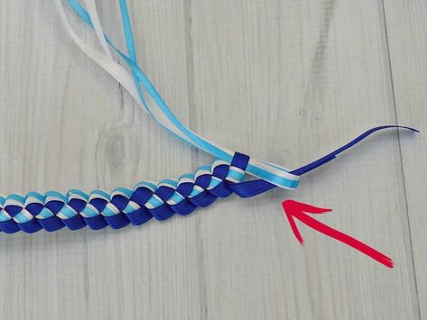 How to make a ribbon lei with 3 colors in about 30 minutes. Hawaiian ribbon leis are traditional made for graduation in the graduate’s school colors. Ribbon Lei 3 Colors Diy, 3 Strand Ribbon Lei Tutorial, Ribbon Leis Diy Tutorials Easy, Hawaiian Ribbon Lei Tutorial, Grad Leis For Boys, Graduation Ribbon Lei Ideas, 3 Ribbon Lei Diy, Ribbon Leis Diy Tutorials, Diy Lei