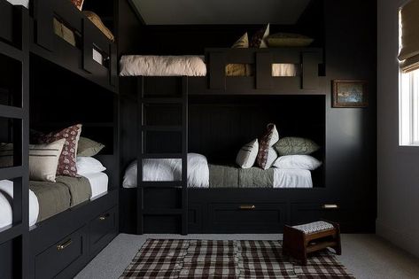 Bedroom features L shaped black built in bunk beds with forest green bedding, a black bunk bed ladder and a brown gingham rug with small wooden stool. Moody Lake House, Mountain Bunk Room, Black Lake House, Black Bunk Beds, L Shaped Bunk Beds, Bunk Bed Ladder, Bunk Beds Built In, Light And Dwell, House Light