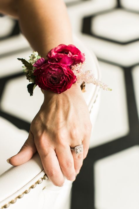 Family Corsages: A cluster of burgundy ranunculus accented with blush astilbe and the greenery of parvifolia eucalyptus on a pearl wristlet Corsages....STEMS | Pearl Events | The Belmont | Mint Photography Burgundy And Blush Corsage, Modern Wrist Corsage Wedding, Modern Wrist Corsage, Simple Wrist Corsage, Blush Astilbe, Ranunculus Corsage, Parvifolia Eucalyptus, Burgundy Corsage, Burgundy Ranunculus