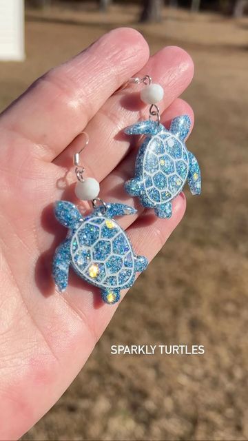 Twilight Grove Jewelry on Instagram: "Check out these sparkly turtle earrings! The holographic glitter is gorgeous and they are super lightweight. Link in bio. #turtle#turtleearrings #beachvibes#holo#handmadejewelry #twilightgrovejewelry #shopsmall#fayettevillenc #handmadegifts #earringsoftheday" Beachy Earrings, Turtle Earrings, Holographic Glitter, Link In Bio, Handmade Jewelry, Glitter, Handmade Gifts, On Instagram, Quick Saves