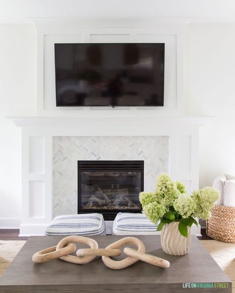 A shaker style fireplace mantle with board and batten and herringbone marble surround. Perfect in this coastal inspired living room! #home #homedecorideas #homedecor #livingroomdecor #livingroom #homeimprovement #fireplace Fireplace Mantel Decor With Tv, Shaker Style Fireplace, Style Fireplace Mantle, Tv Over Fireplace, Style Fireplace, Living Room Transformation, Driven By Decor, Small Family Room, Fireplace Mantel Decor