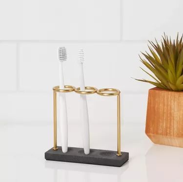 12 Modern Toothbrush Holders | Hunker Toothbrush Holder Ideas, Rental Bathroom, Concrete Bathroom, Wrought Iron Candle, Bathroom Storage Solutions, Toothpaste Holder, Iron Candle Holder, Bathroom Toothbrush Holder, Century Decor