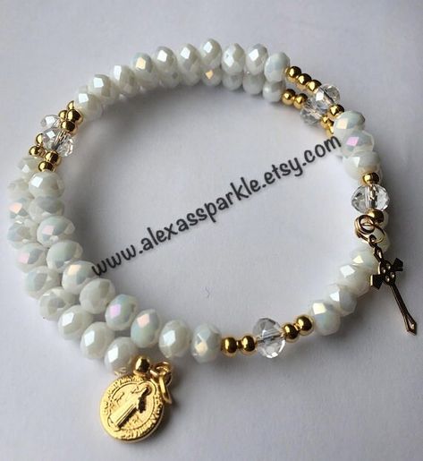 The bracelets are made with gold colored memory wire. The beads are crystal rondelle size 6mm of a white color. The bracelet is made as a Rosary bracelet and each of it's sections is separated by a crystal rondelle bead. The charms are gold plated. The bracelets will fit most wrists as they expand. The bracelets are sold by the dozen and make great favors or gifts for religious celebrations such as baptisms, confirmations, first communions, etc. If you have any questions or would like a custom o Memory Bracelets, White Rosary, Memorial Bracelet, Rose Bracelet, Rosary Bracelet, Protection Bracelet, Memory Wire, Evil Eye Bracelet, Organza Bags