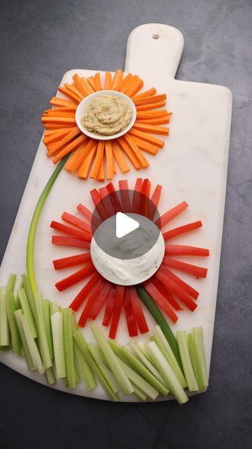 @inox.artisans on Instagram: "Happy Tuesday! We hope your week is going well, but just in case it isn't...we brought you flowers.   Why not break up the week with this fun veggie flower platter? Served on our beautiful artisan-crafted Cortar Marble Charcuterie Board, this veggie and dip snack is a real crowd-pleaser.   Visit our website and check out our recipe section for easy prep appetizers and more!   🌻🌻🌻  #veggieplatter #veggieplatterlove #veggiedips #marble #marblecharcuterieboard" Charcuterie Flowers, Veg Tray, Marble Charcuterie Board, Pink Flower Decor, Veggie Board, Veggie Dip, Snack Tray, Crowd Pleaser, Flower Decor