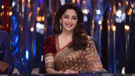 Madhuri Dixit looking beautiful in a maroon velvet blouse with puffed sleeves and a saree of beige net. Maduri Dixit, Velvet Blouse Design, Latest Saree Blouse, Blue Blouse Designs, Cotton Saree Blouse Designs, Boat Neck Blouse Design, Blouse Indian, Velvet Blouse, Party Sarees