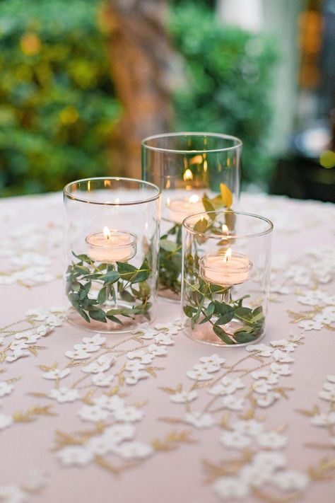 Garland And Tea Lights, Floating Tealight Centerpiece, Floating Candle With Greenery, Mason Jars With Floating Candles, Tea Lights In Water, Tea Light Candles In Water Wedding, Floating Lights Wedding, Boho Floating Candle Centerpieces, Tea Light Centerpiece Wedding