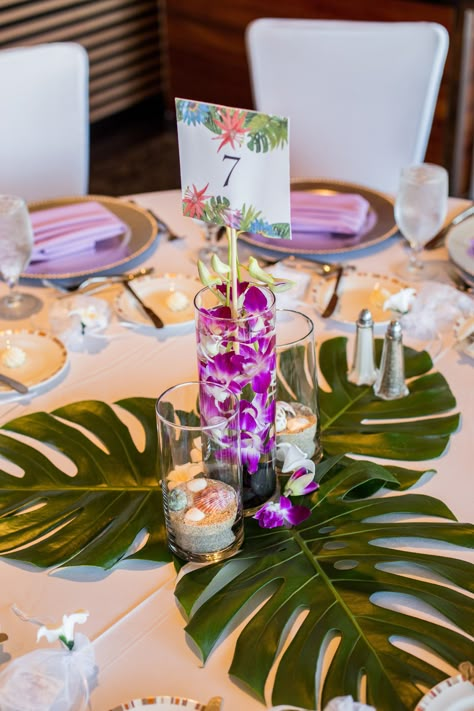 One of our tropical centerpieces with monstera leaves. The other tables alternated between monstera and palm leaves. Tropical Centerpieces, Greenery Wedding Centerpieces, Tafel Decor, Fiesta Tropical, Luau Theme, Tropical Home Decor, Reception Centerpieces, Hawaiian Theme, Hawaiian Party