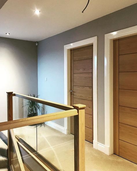 • our upstairs hallway. Oak doors with oak and glass banister. Light grey paint on the walls. Still needs a few pictures and a plant. #upstairs #hallwayideas #glassbalustrade #oak #interiordesign #homedecor White Oak Interior Doors, Upstairs Hallway Decorating, White Oak Interior, Glass Banister, White Banister, Garden Staircase, Interior Doors Modern, Oak Interior Doors, House Staircase