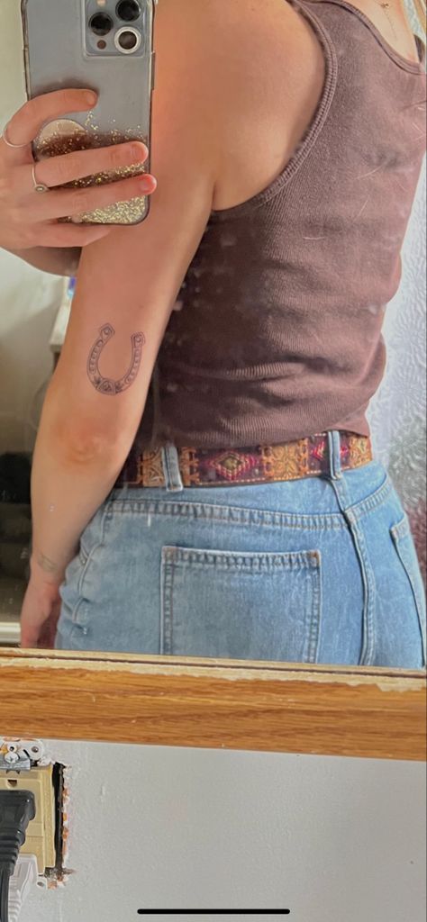 Punchy Western Tattoos Simple, Fineline Cowgirl Tattoo, Western Tattoos Forearm, Horse Saddle Tattoo, Fineline Horseshoe Tattoo, Western Horseshoe Tattoo, Western Feminine Tattoos, Horse Arm Tattoo, Country Themed Tattoos For Women