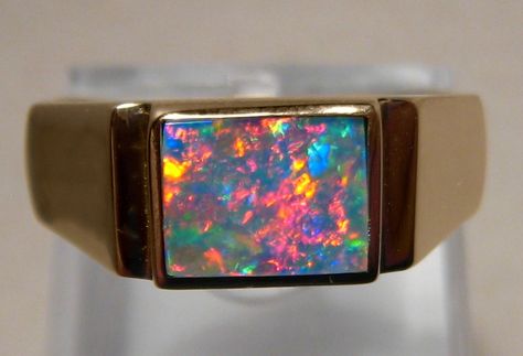 A quality opal ring for men with a rectangle red and blue opal in 14k yellow gold. Inquire to buy in any ring size or gold color. Opal Ring Men, Opal Ring For Men, Mens Jewelry Pendants, Patio Privacy Screen, Patio Privacy, Unique Opal, Mens Gemstone Rings, Colored Stone Rings, Opal Ring Gold