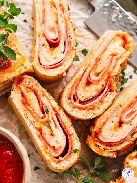 Ham, pepperoni, salami, and cheese are rolled up in refrigerated pizza dough in this Easy Stromboli recipe. It's saucy, cheesy, and super easy to make. Feel free to customize it with your favorite toppings! Ham And Cheese Stromboli, Cheese Stromboli, Easy Stromboli, Stromboli Recipe Easy, Homemade Stromboli, Refrigerated Pizza Dough, Salami And Cheese, Delicious Pizza Recipes, Pepperoni Rolls