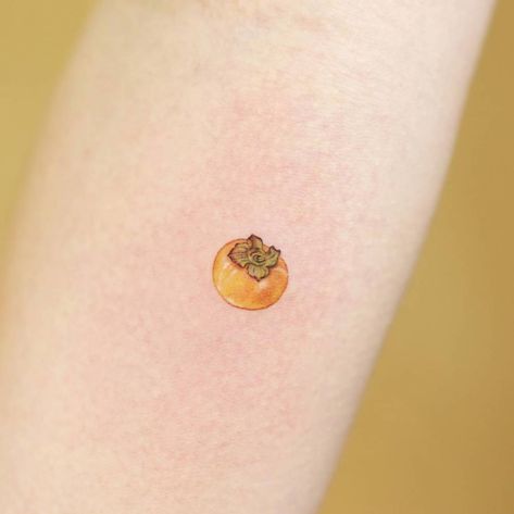 Tiny persimmon tattoo done on the inner forearm. Persimmons Tattoo, Mangosteen Tattoo, Tiny Fruit Tattoo, Kumquat Tattoo, Persimmon Drawing, Apricot Tattoo, Small Fruit Tattoos, Persimmon Tattoo, Tangerine Tattoo