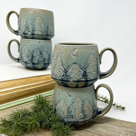 I'm planning to make another batch of these mountain mugs soon-- I'm putting handles on the mug forms today, and in a couple days they will be ready to carve! I love the subtle way the Blue Ridge glaze highlights this carved design-- it's a softer look than my blue/gray inlay, and sometimes that is exactly what my eye craves. Mountain Mug Pottery, Pottery Mug Handles Ideas, Slab Mug Ideas, Mug Forms, Mountain Mugs, Carved Mugs, Pottery Brand, Pottery Handles, Mountain Mug