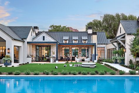 “I think the way we used the reclaimed brick, basalt stone details, and metal and slate roofs really speaks to the artisan-crafted home,” says architect Matthew Thomas of an Arcadia home. “It’s about creating a story.” Modern Traditional Home Exterior, Industrial Farmhouse Decor, Transitional Farmhouse, Industrial Home Design, Basalt Stone, Reclaimed Brick, Farmhouse Decor Ideas, Modern Ranch, Modern Farmhouse Exterior