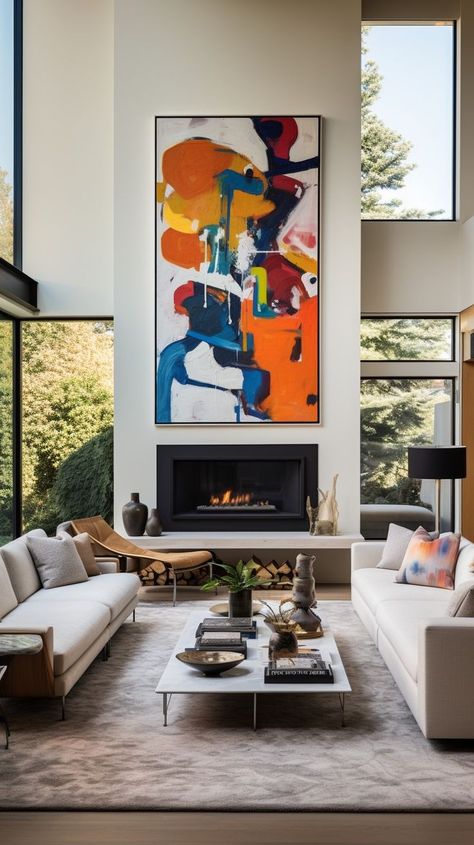 Modern living room with colorful abstract painting above fireplace, natural light, neutral-toned furnishings. Ideal setting for relaxation and entertainment. Above Fireplace Ideas Modern, Fireplace Double Height, Art For Tall Walls High Ceilings, Modern Fireplace Decor, Above Fireplace Ideas, Ceiling Artwork, Terrace Extension, Artistic Interior Design, Sleek Fireplace