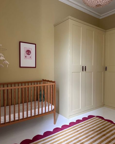 Farrow & Ball Hay No.37 is a dusty, modest yellow that has a distinctly green undertone which gives it an established feel, creating peaceful spaces. We think it fulfilled its obligation in this lovely nursery, don’t you? Walls and wardrobe painted in Hay Dead Flat. 📸: @joannalari Repost: @farrowandball Sample pots available at Hirshfield’s Edina and Roseville locations. Eclectic Baby Nursery, Yellow Nursery Walls, Yellow Baby Room, Yellow Kids Rooms, Half Painted Walls, Eclectic Nursery, Dusty Yellow, Yellow Ceiling, Yellow Paint Colors