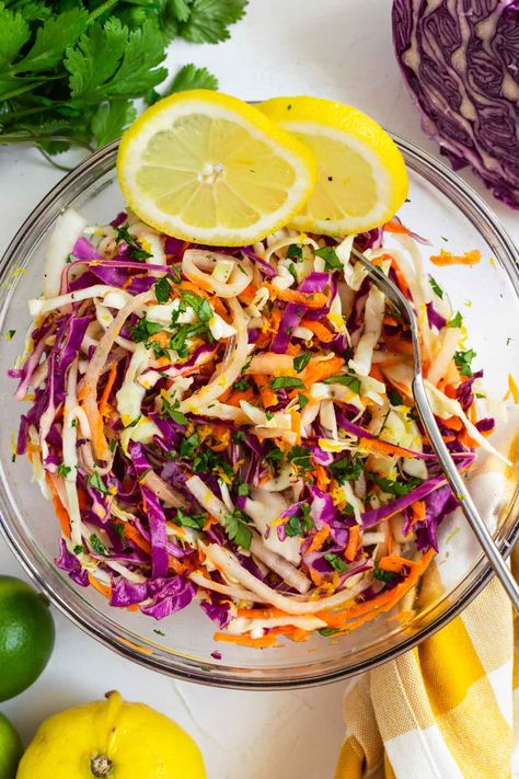 This sweet citrus slaw is a deliciously crisp, tangy and lightly sweet mix of green cabbage, red cabbage, and carrots topped with a bright blend of orange, lime, and lemon juice, olive oil, and maple syrup. This recipe has been a family favorite for folding into fish and shrimp tacos, layering into wraps and bowls, or pairing as a tart side with grilled burgers, chicken, or steak. #citrusslaw #citruscoleslaw #slaw #slawrecipe #cabbageslaw #bbqsidedish Mexican Coleslaw Recipe, How To Shred Cabbage, Citrus Slaw, Mexican Coleslaw, Cabbage And Carrots, Lime And Lemon, Healthy Coleslaw, Homemade Coleslaw, Broccoli Slaw