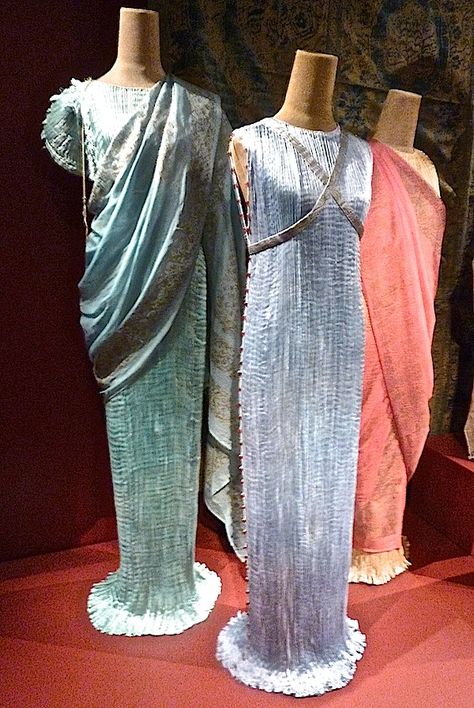 Because Fortuny was not a fashion designer per se, he could afford to disregard trends and his designs remained true to his vision for decades. By 1925, the Delphos was considered a tea gown and by the 30′s was adopted as an evening dress, known for its columnar shape, elaborate pleating and Venetian glass beads, which served as both decoration and to anchor the featherweight silk, Delphos Dress, Delphos Gown, Fortuny Dress, Fortuny Fabric, Mariano Fortuny, 1920 Dress, Tea Gown, Jeanne Lanvin, 1930s Dress