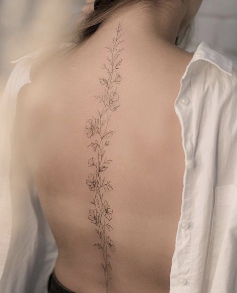 Daffodil Tattoo On Spine, Moon Flower Spine Tattoo, Delicate Floral Spine Tattoo, Simple Spinal Tattoo Women, Tree Branch Spine Tattoo, Spin Tattoos For Women Flowers, Floral Spine Tattoo With Quote, Spinal Flowers Tattoo, Marigold Vine Tattoo