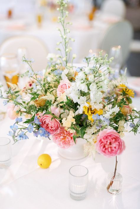 Whimsical and Colorful, Low Floral Arrangement With Pink, Blue, Yellow and White Flowers Spring Wedding Flowers Centerpieces Table Arrangements, Spring Wedding Flowers Centerpieces, Yellow Flower Arrangements, Wedding Color Schemes Blue, Colorful Centerpieces, Yellow And White Flowers, Light Pink Wedding, Spring Wedding Flowers, Wedding Colors Blue