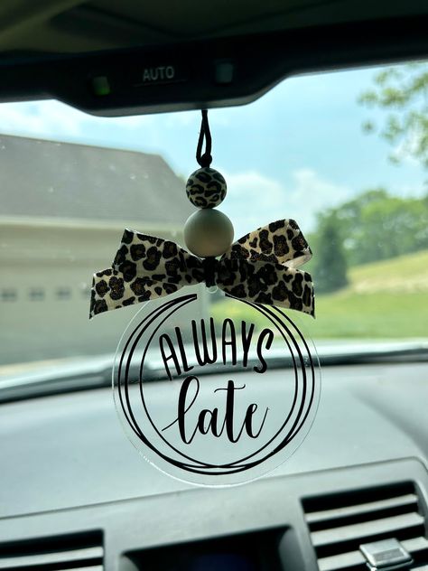 This adorable "always late" leopard print car charm/rearview mirror charm is the perfect vehicle accessory!!  Product comes with the following: black durable nylon - standard 25" from end to end  1 wood bead 1 silicone bead 3" acrylic disc leopard print bow black vinyl lettering *nylon cord is adjustable to suit your personal preference by tying knot at the desired length.   *this is a single sided car charm CAUTION:  Many items in this shop contain small parts and potentially present a choking hazard.  Please never allow children unattended while using these products.  All of my products should be used with adult supervision.  The buyer assumes all responsibility for its use. I take pride in my work & stand behind my products 100%.  If there is something you are not happy with, please mes Mirror Hangers For Cars, Rearview Mirror Decal, Rearview Mirror Decoration Diy, Acrylic Car Charms, Xtool Projects, Personalized Car Tags, Car Mirror Decorations, Car Hanging Accessories, Vinyl Board