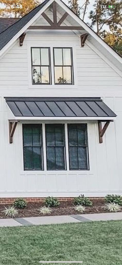 Window Gables On House Exterior, Garage Metal Awning, Farmhouse Awning, Garage Portico, Ranch House With Awnings, Metal Roof Awning Over Door, Farmhouse Window Awnings Exterior, Dormers Ideas Exterior Farmhouse, Exterior Window Awnings