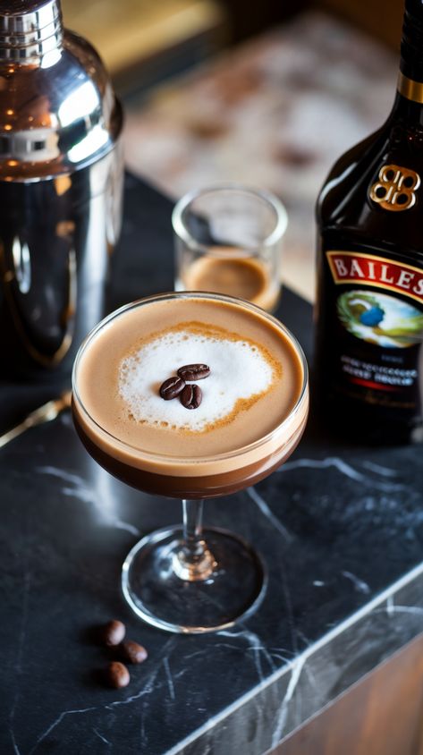 Overhead view of Baileys Espresso Martini in glass with coffee beans, cocktail shaker, espresso shot, and Baileys bottle on dark marble countertop. Baileys Espresso Martini, Baileys Coffee Recipes, Baileys Espresso Martini Recipe, Esspreso Martini Recipe, Diy Baileys, Espresso Martini Recipe Baileys, Espresso Martini With Baileys, Creamy Espresso Martini, Martini With Baileys