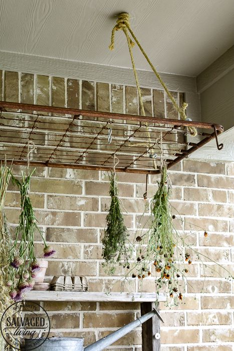 The perfect plant drying rack for your patio. If you want a French country feel on your porch then a vintage baby mattress spring is the best idea! Maybe you can even use it for a herb drying rack if you are a foodie! #herbdryingrack #diydryingrack #wildflowers #herbdrying #cozyporch #porchquilt Flower Drying Rack, Herb Drying Rack, Flower Drying, Mattress Spring, Herb Rack, Herb Drying, Hanging Herbs, Baby Mattress, Kitchen Herbs