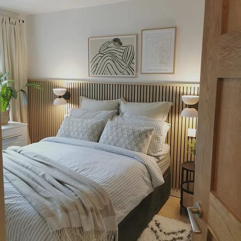 A Scandinavian getaway inspired bedroom in Boothstown.We added midi oak slat paneling on the bedhead wall, a fresh coat of paint, gorgeous light sconces, linen drapes, and all important plants and cosy textures for a hygge feel.Swipe to the end to see the 'before'naturewalluk Bedroom Wooden Panelling Accent Walls, Panelling Bed Headboard, Wood Slat Feature Wall Bedroom, Cladded Bedroom Wall, Bedroom Slat Panelling, Bedroom Ideas Black And Cream, Slat Wall Panelling Bedroom, Wooden Panel Behind Bed, Bedroom Wooden Slat Wall